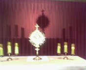 Monstrance and two candles on a table